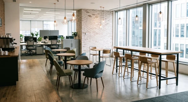 Round café and breakout tables in a bright social space